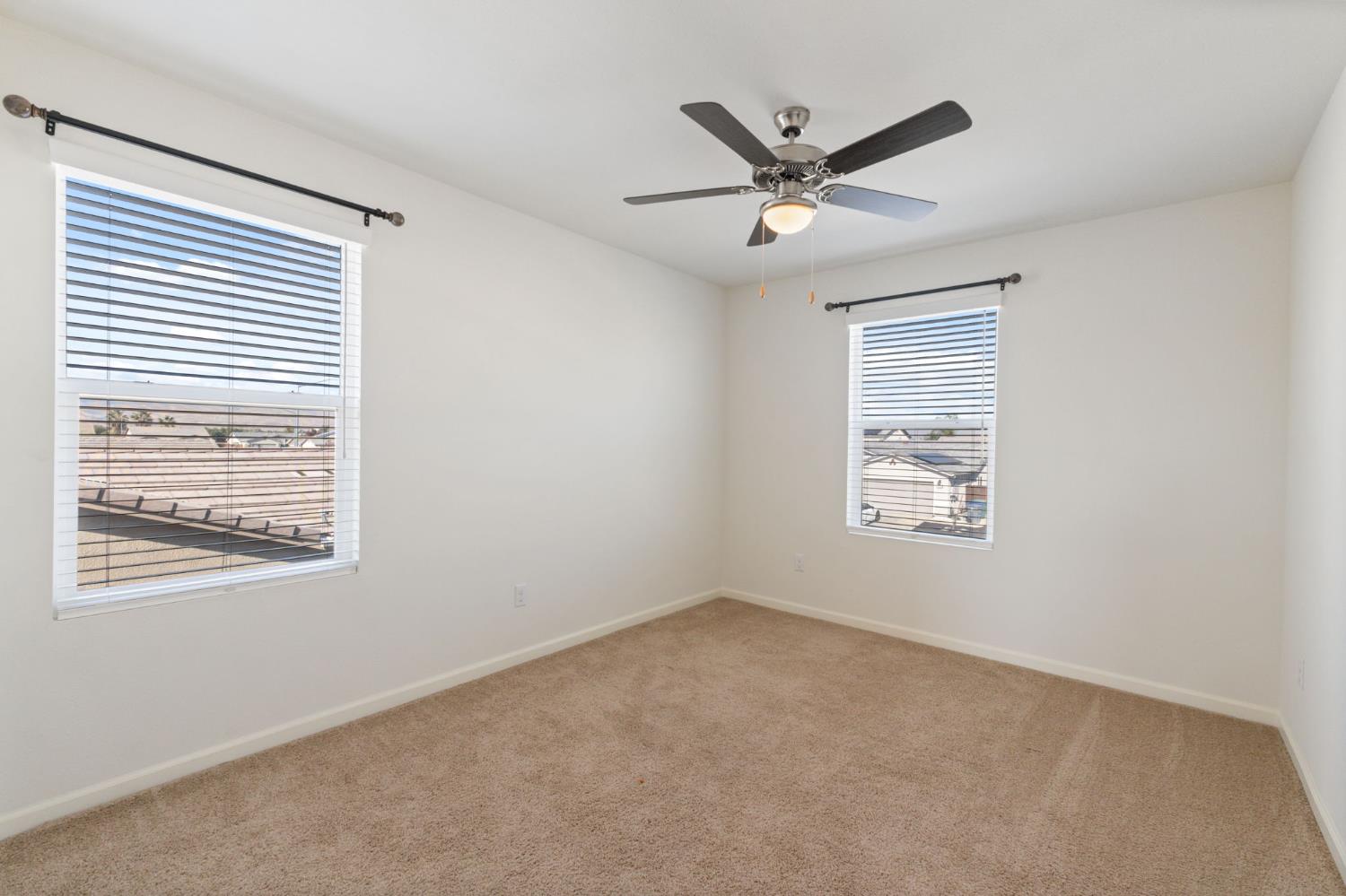 802 Riesling Lane Coalinga, CA 93210 - Photo 27 of 68 a view of a big room with windows and fan
