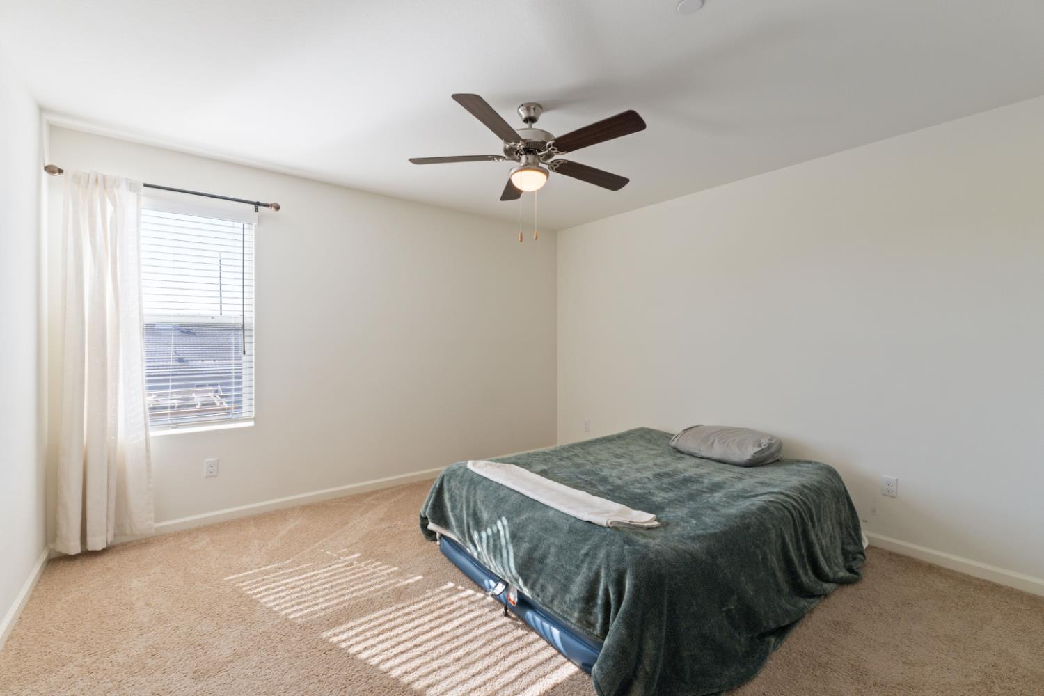 802 Riesling Lane Coalinga, CA 93210 - Photo 30 of 68 a bedroom with a bed and a window