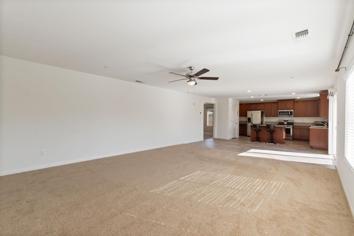 802 Riesling Lane Coalinga, CA 93210 - Photo 10 of 68 a view of a livingroom with a furniture and a kitchen