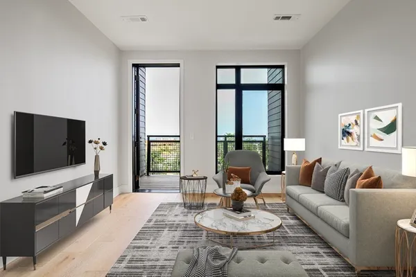a living room with furniture and a flat screen tv