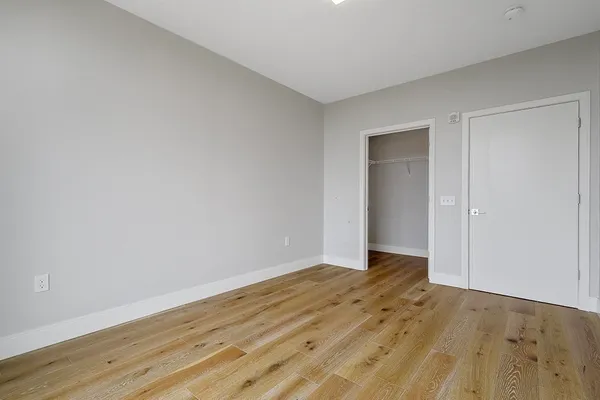 a view of an empty room and wooden floor