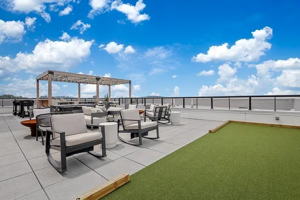 a view of swimming pool with outdoor seating and plants
