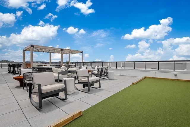 a view of swimming pool with outdoor seating and plants