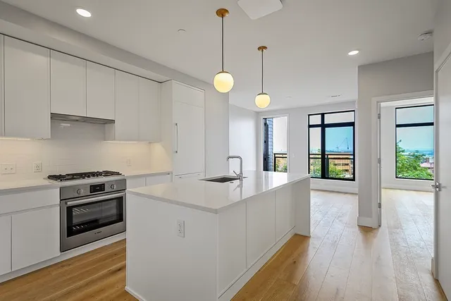 a kitchen with stove and cabinets