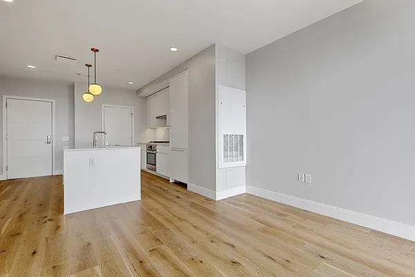 a view of a kitchen with wooden floor and a sink
