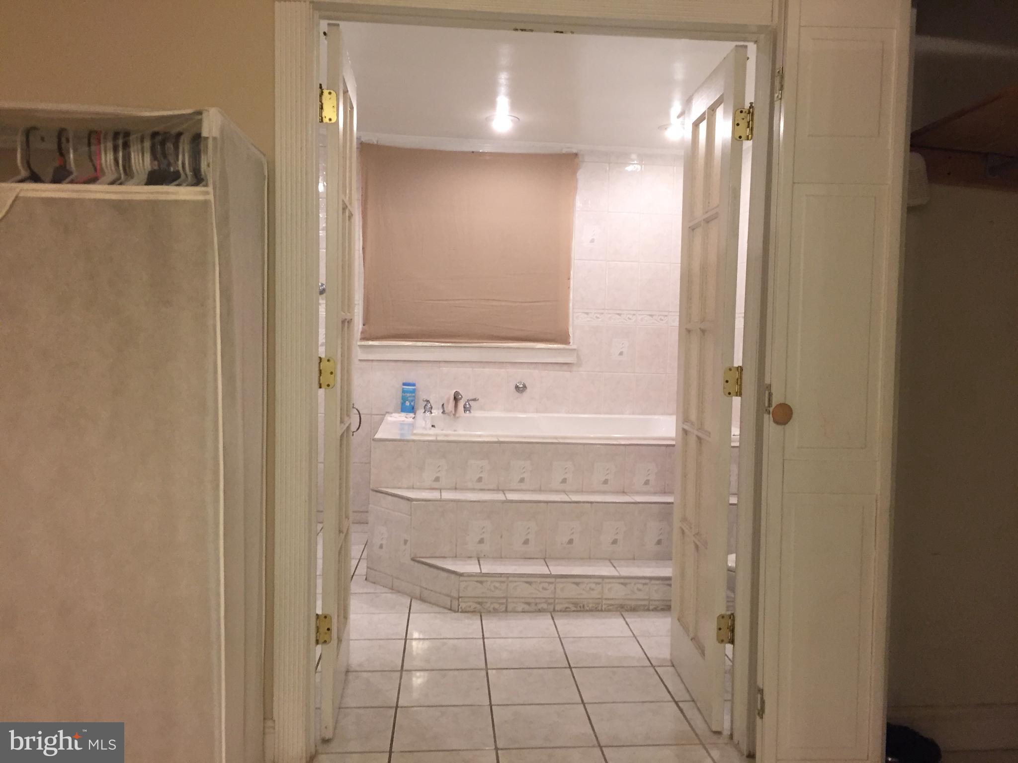 2618 Waterloo Street Philadelphia, PA 19133 - Photo 12 of 15 a bathroom with a sink a mirror and a bathtub