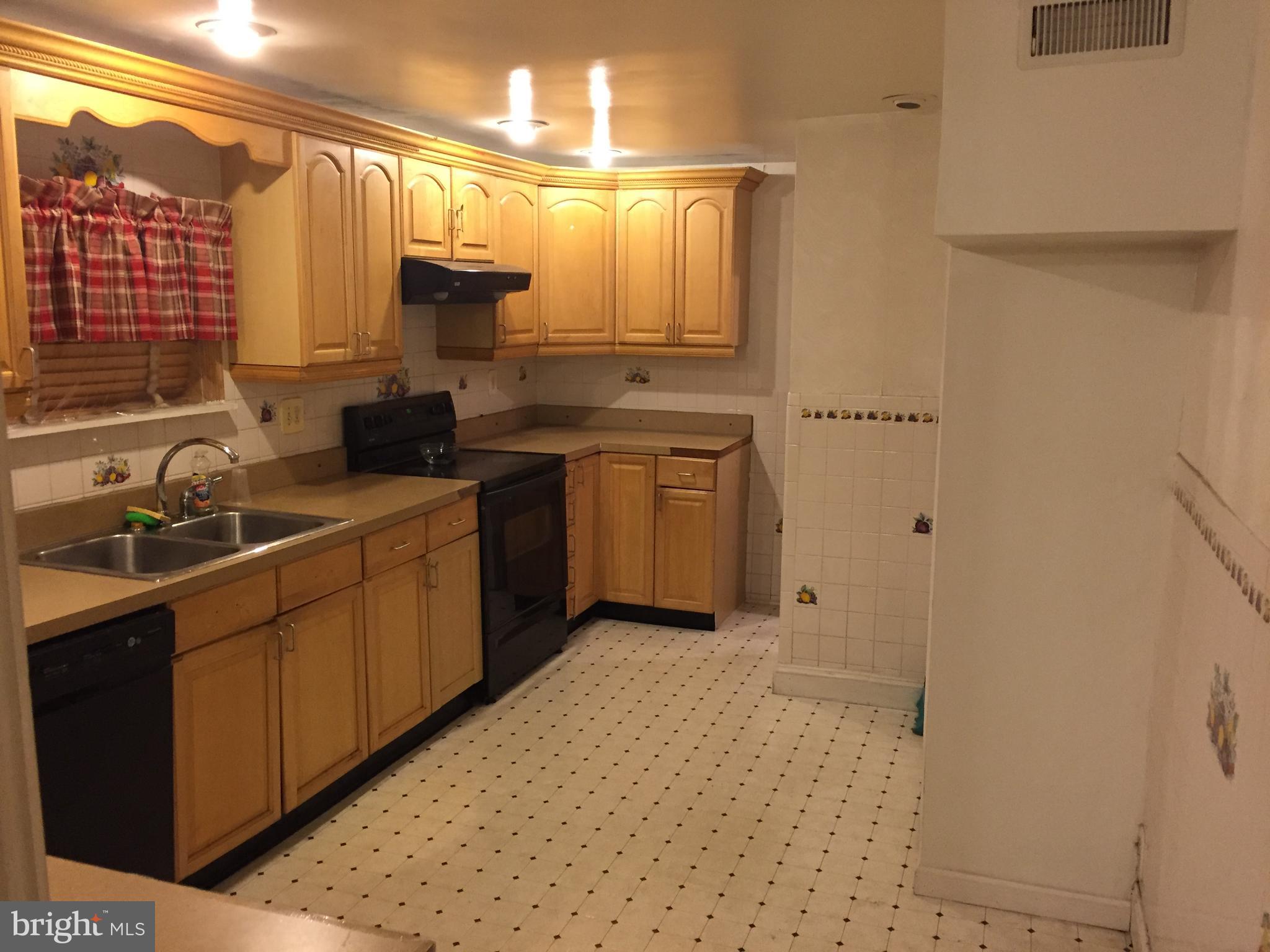 2618 Waterloo Street Philadelphia, PA 19133 - Photo 5 of 15 a kitchen with a sink cabinets and window