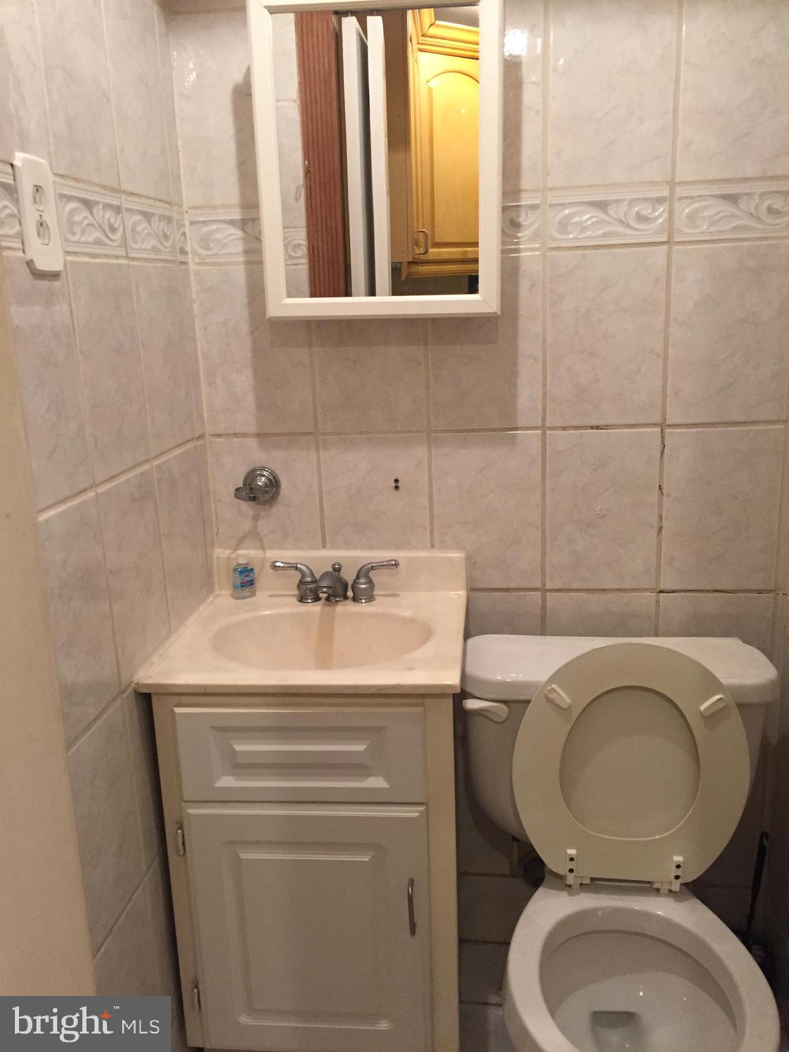 2618 Waterloo Street Philadelphia, PA 19133 - Photo 7 of 15 a bathroom with a sink a toilet and mirror