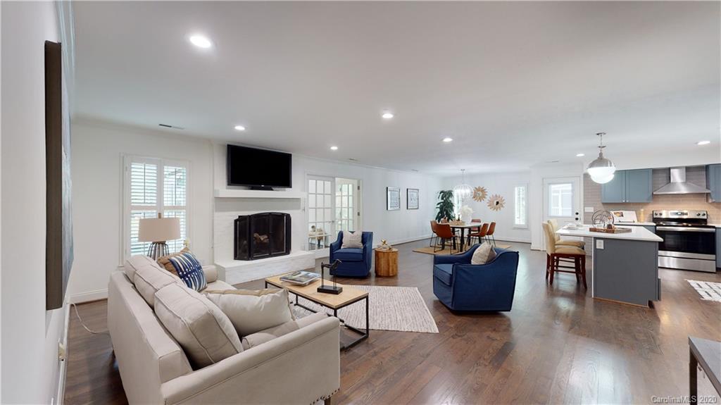 244 Scofield Road Charlotte, NC 28209 - Photo 13 of 30 a living room with furniture a fireplace and a flat screen tv