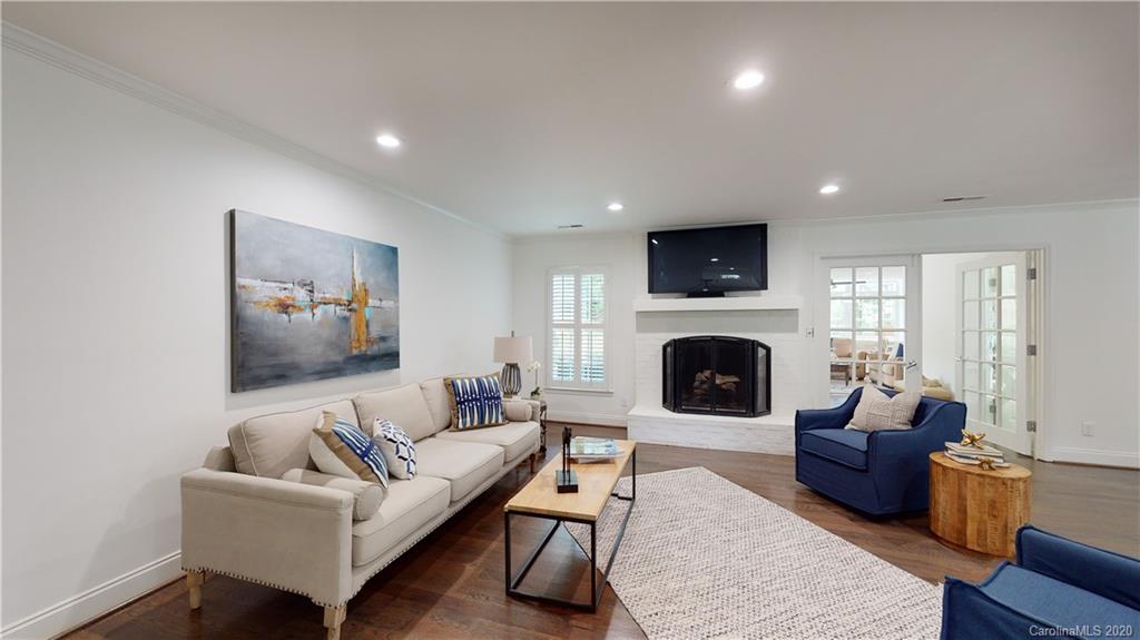 244 Scofield Road Charlotte, NC 28209 - Photo 14 of 30 a living room with furniture a flat screen tv and a fireplace
