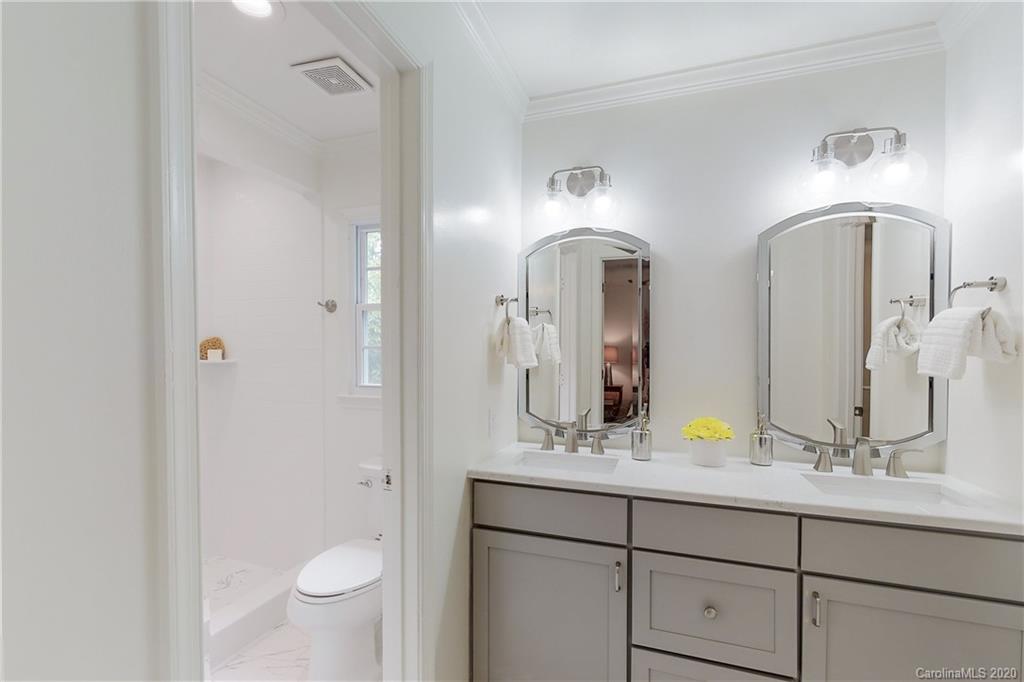 244 Scofield Road Charlotte, NC 28209 - Photo 15 of 30 a bathroom with double vanity sinks and a mirror