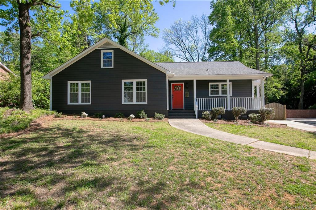 244 Scofield Road Charlotte, NC 28209 - Photo 3 of 30 a brick house next to a yard with potted plants and large trees