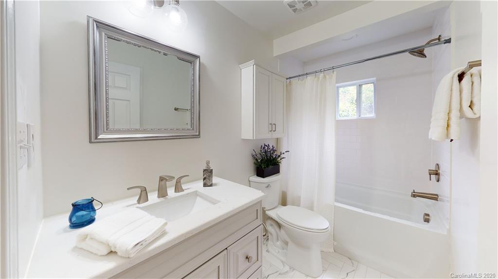 244 Scofield Road Charlotte, NC 28209 - Photo 28 of 30 a bathroom with a granite countertop sink toilet and shower