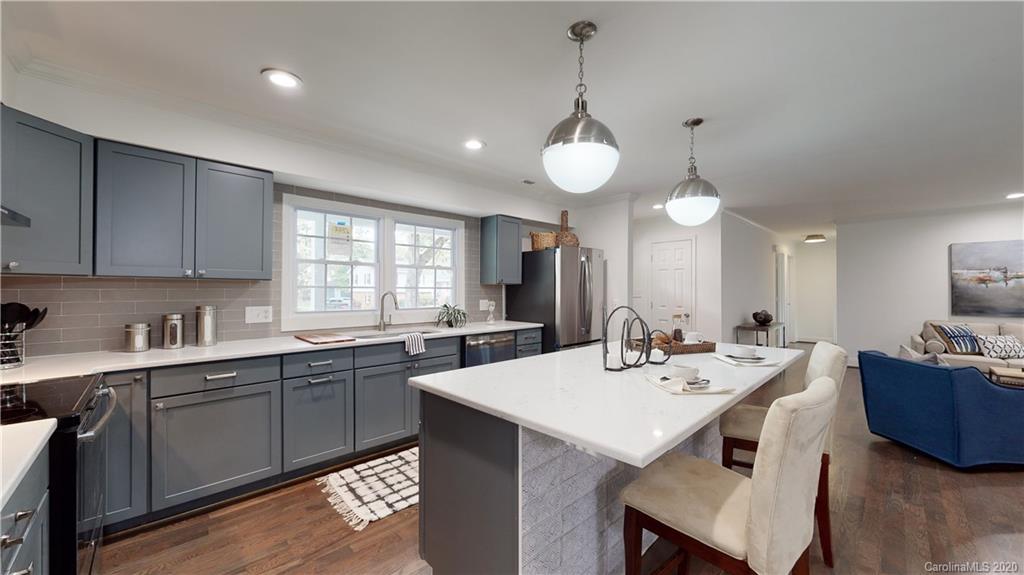 244 Scofield Road Charlotte, NC 28209 - Photo 4 of 30 a kitchen with a sink a center island and cabinets