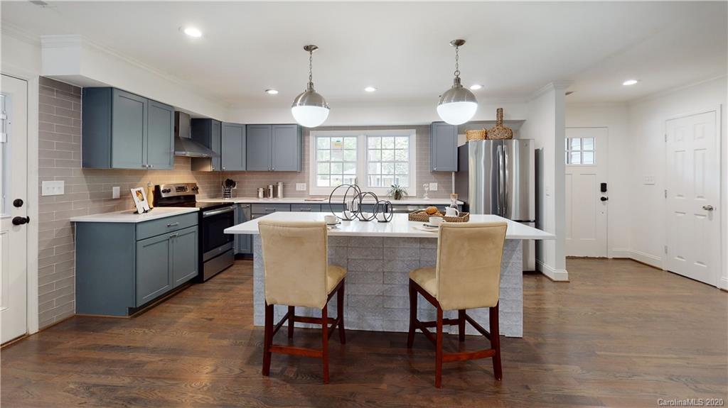 244 Scofield Road Charlotte, NC 28209 - Photo 7 of 30 a kitchen with stainless steel appliances granite countertop a dining table chairs refrigerator sink and cabinets