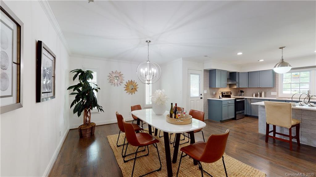 244 Scofield Road Charlotte, NC 28209 - Photo 10 of 30 a view of a dining room and livingroom with furniture wooden floor a chandelier