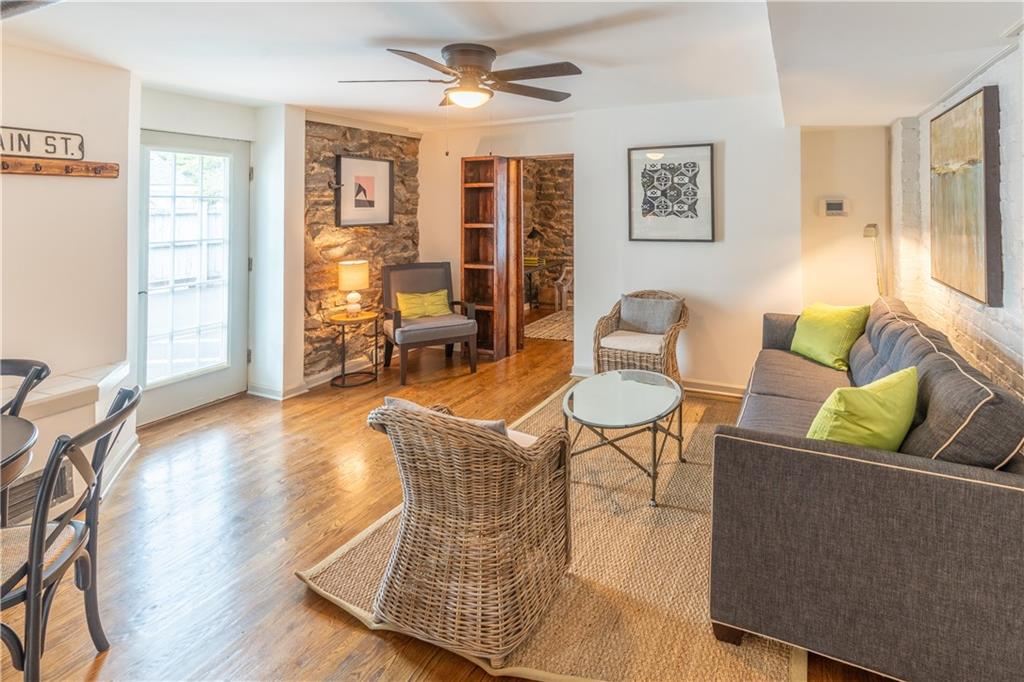 28 Collier Road Northwest, Unit 13 Atlanta, GA 30309 - Photo 1 of 1 a living room with furniture and wooden floor