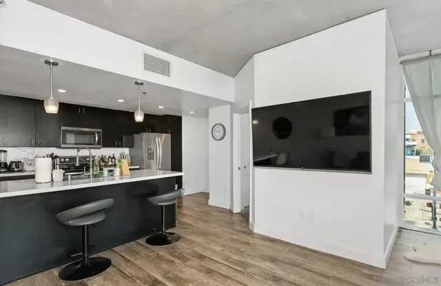 a kitchen with stainless steel appliances granite countertop a sink a stove and a refrigerator