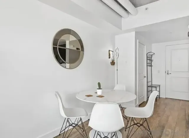 a living room with furniture and view of kitchen