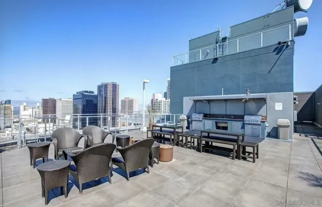 a view of a balcony with furniture and a potted plant