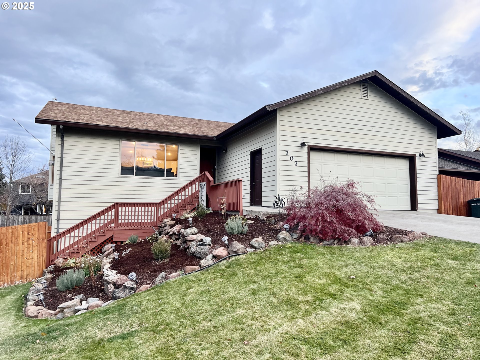 a front view of a house with a garden