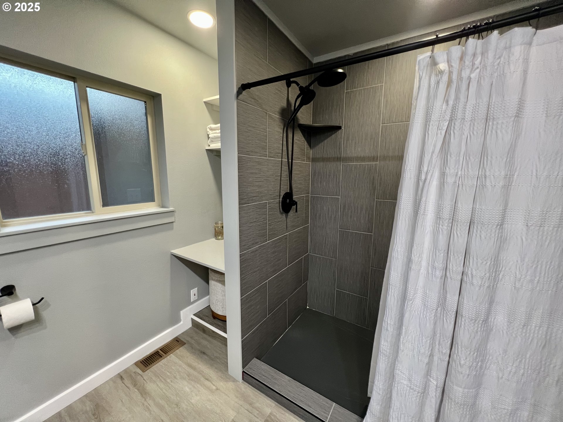 707 Highland Drive La Grande, OR 97850 - Photo 12 of 28 a bathroom with a glass door shower and toilet