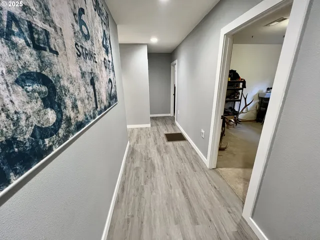 a view of hallway with wooden floor