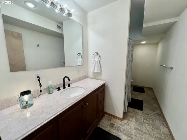 a bathroom with a double vanity sink and mirror