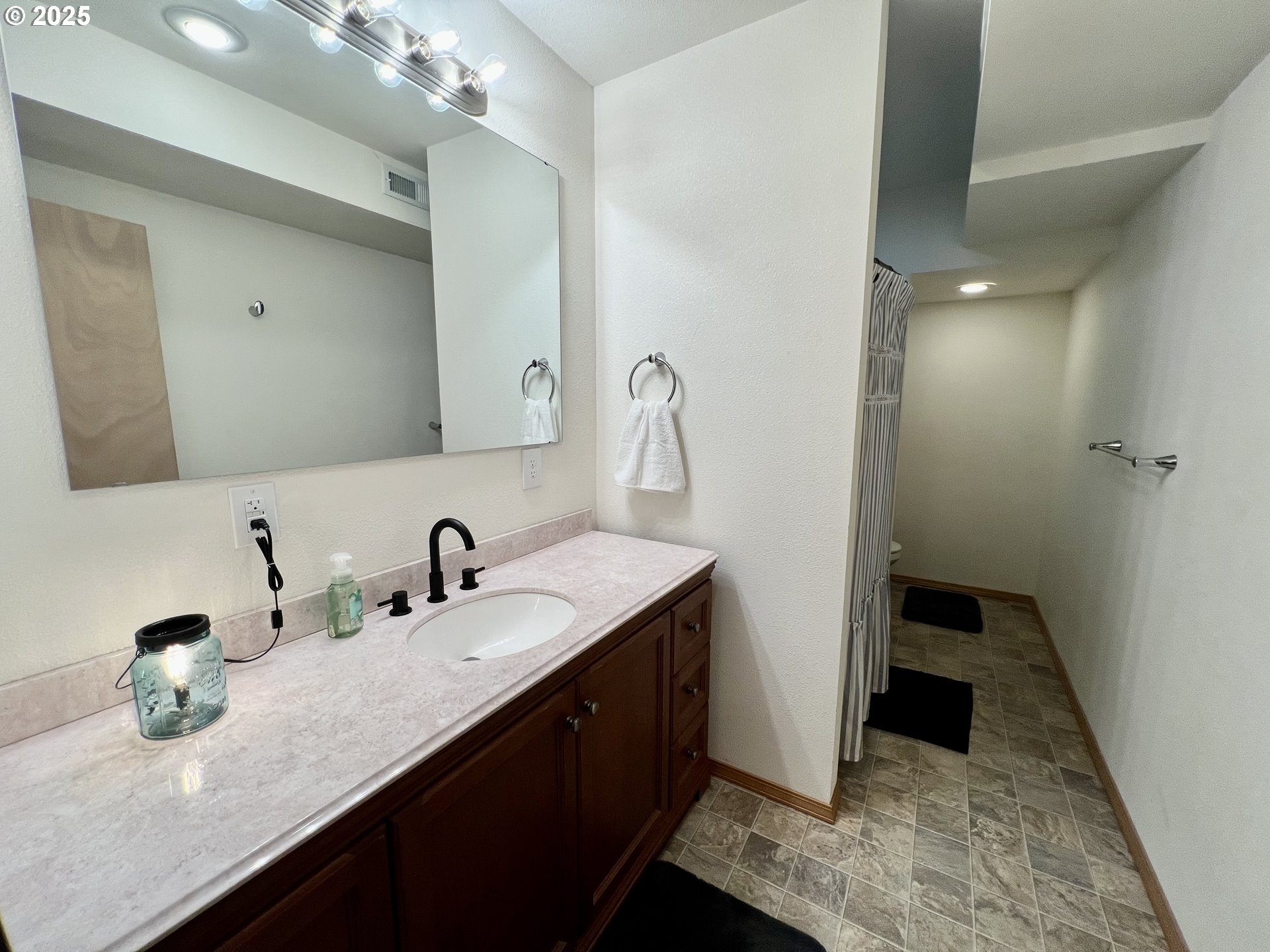 707 Highland Drive La Grande, OR 97850 - Photo 23 of 28 a bathroom with a double vanity sink and mirror