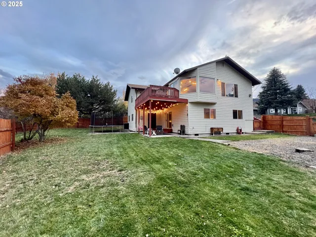 a view of house with backyard