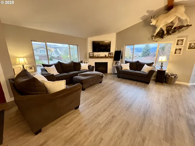 a living room with fireplace furniture and a flat screen tv