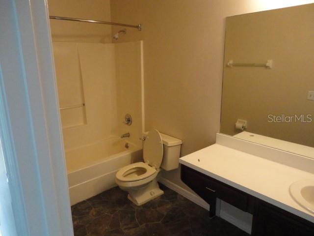 5841 Southwest 8th Place Gainesville, FL 32607 - Photo 12 of 15 a bathroom with a sink a toilet and shower