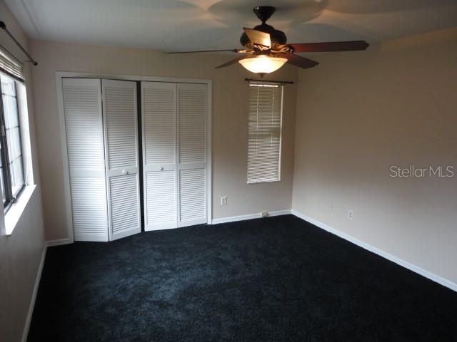 5841 Southwest 8th Place Gainesville, FL 32607 - Photo 8 of 15 an empty room with windows and fan