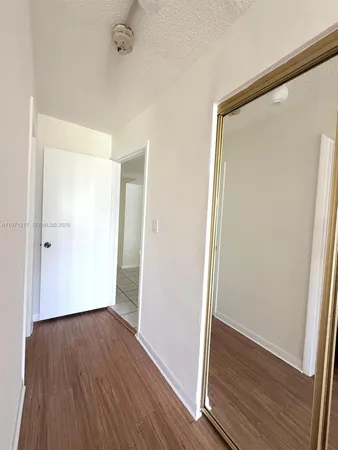 an empty room with wooden floor