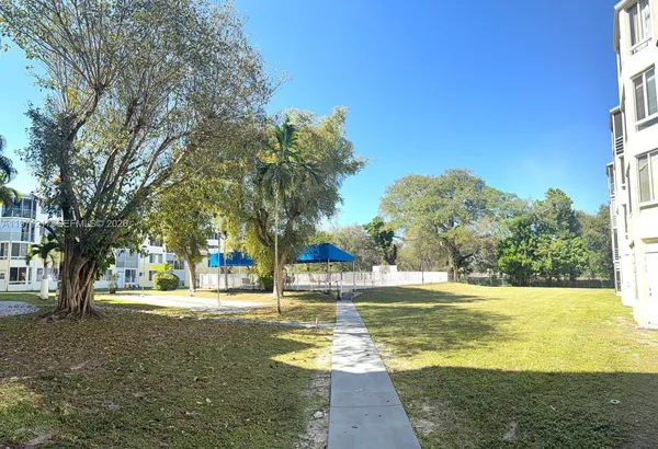 a view of a yard with swimming pool