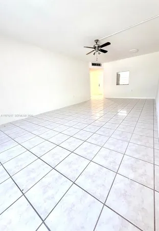 a view of a ceiling fan and window