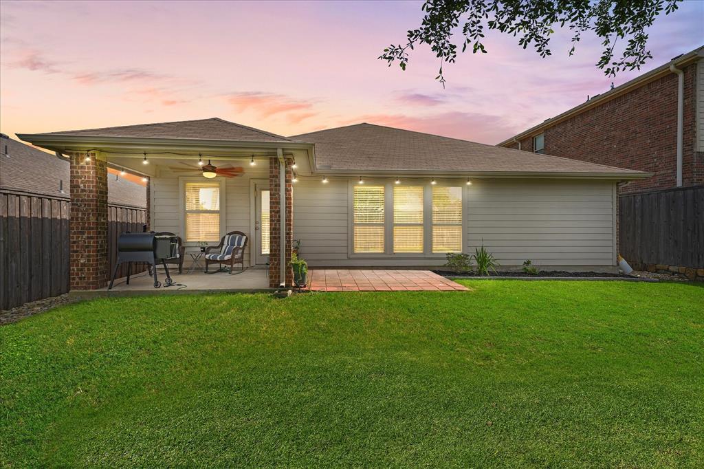 409 Harding Lane Lavon, TX 75166 - Photo 27 of 34 Spacious backyard with a covered patio, string lighting, and a ceiling fan