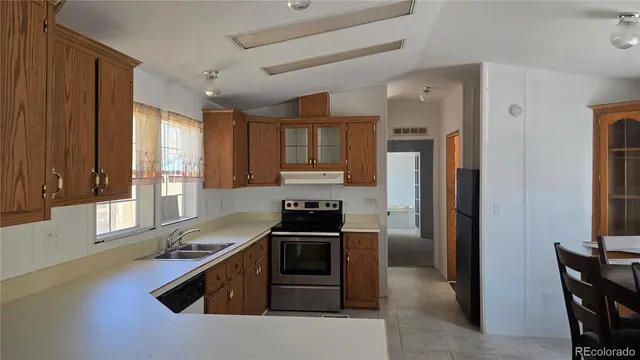a kitchen with granite countertop a stove and a refrigerator