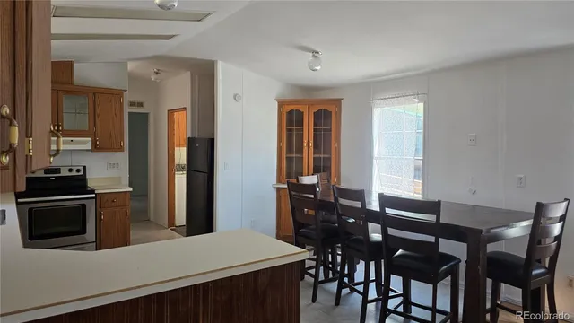 a view of a dining room with furniture and window