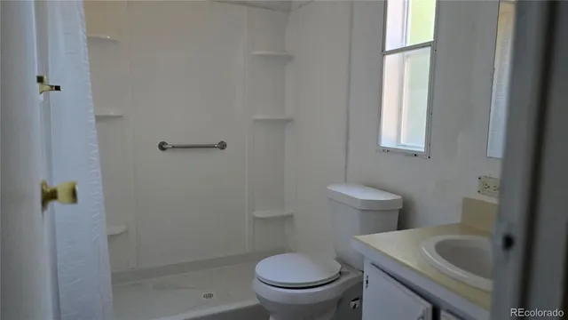 a white toilet sitting next to a bathroom sink