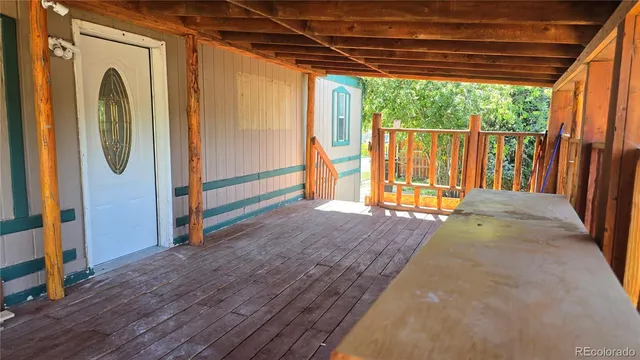 a view of a porch with wooden floor and outdoor space