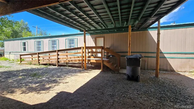a view of a porch with furniture and a backyard