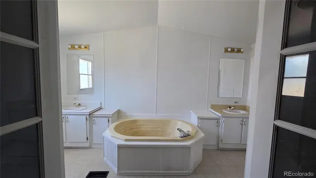 a bathroom with a granite countertop sink and mirror