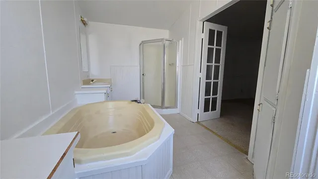a bathroom with a tub and shower