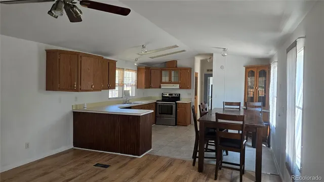 a kitchen with stainless steel appliances granite countertop a sink a stove and a refrigerator