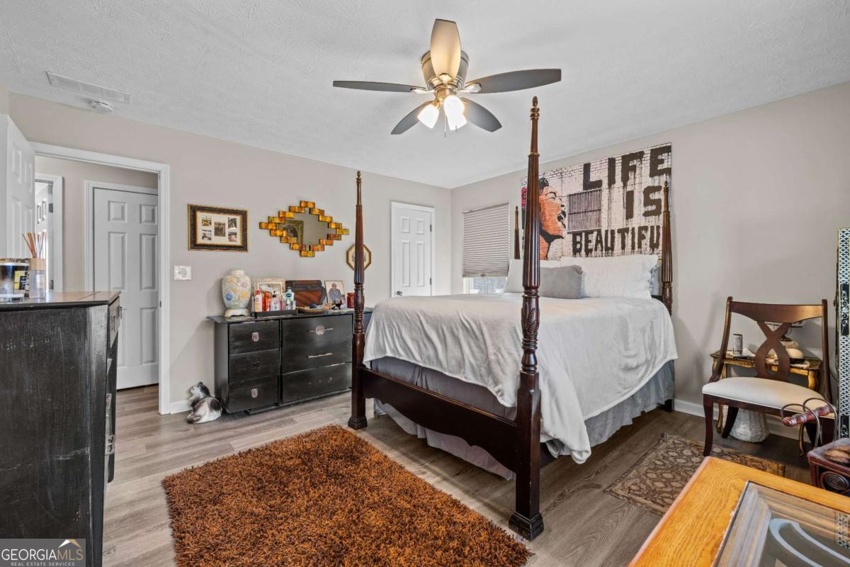 6324 Amberly Road Rex, GA 30273 - Photo 16 of 22 a bedroom with a bed and a dresser in it