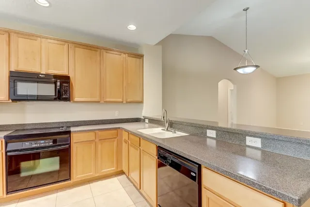 a kitchen with a stove a sink and a microwave