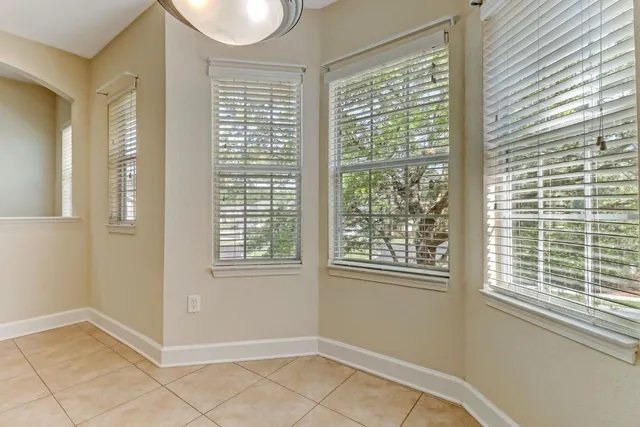a large kitchen with a refrigerator a stove and a sink