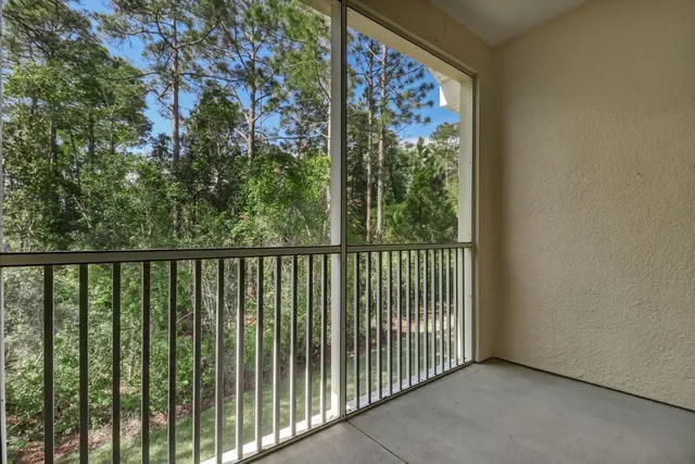 a view of a balcony with wooden floor