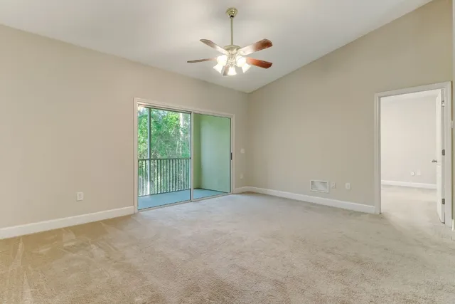 an empty room with a empty space and a ceiling fan